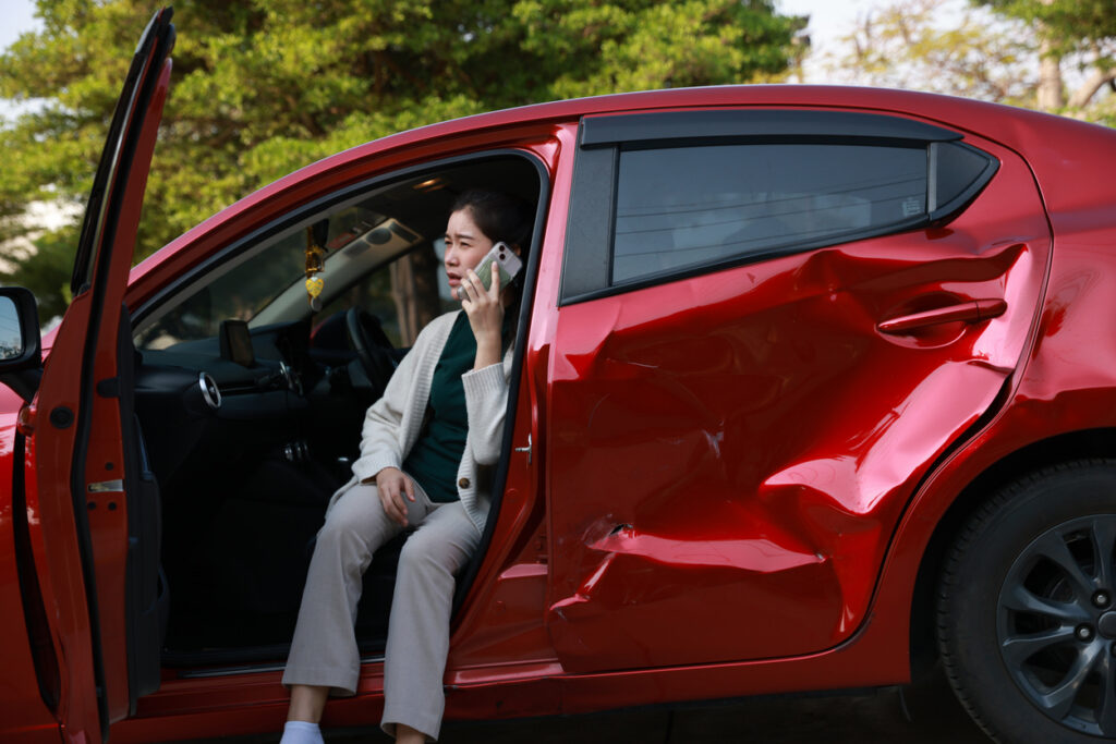 Driver calling for help after a car accident in Tampa, Florida, with legal guidance from Winer Law Group.
